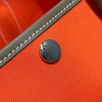 GARDEN PARTY 30CM IN ORANGE MINIMUM TOILETS COTTON CANVAS AND BROWN CALFSKIN