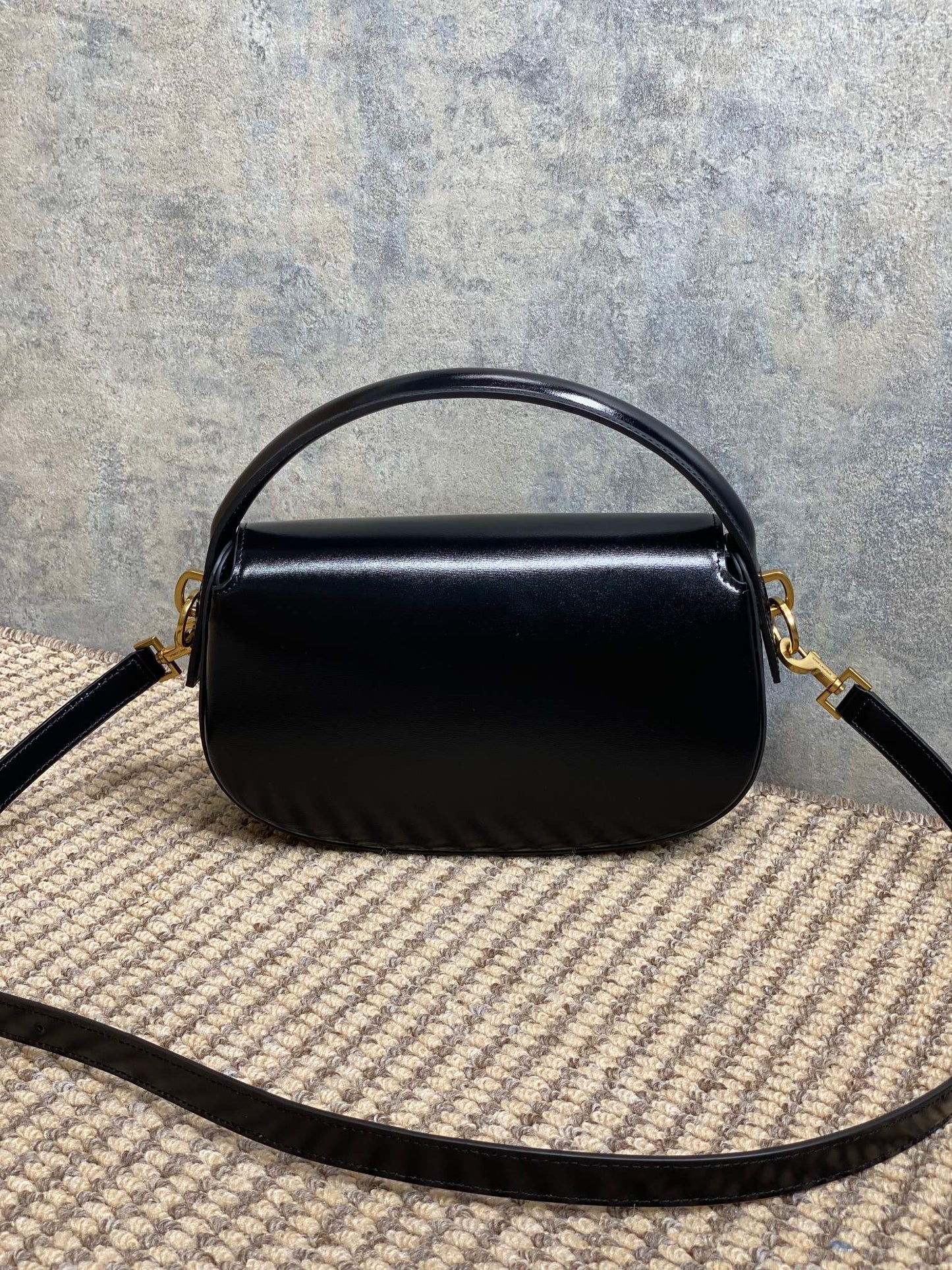 VOLTAIRE HALF-MOON SHOULDER BAG 24 IN BLACK CALFSKIN GOLD METALLIC