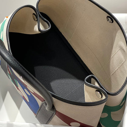 GARDEN PARTY 36 IN MULTICOLOR TOILE H CANVAS BLACK CALFSKIN OVERLAPPING POLKA RINGS PRINT